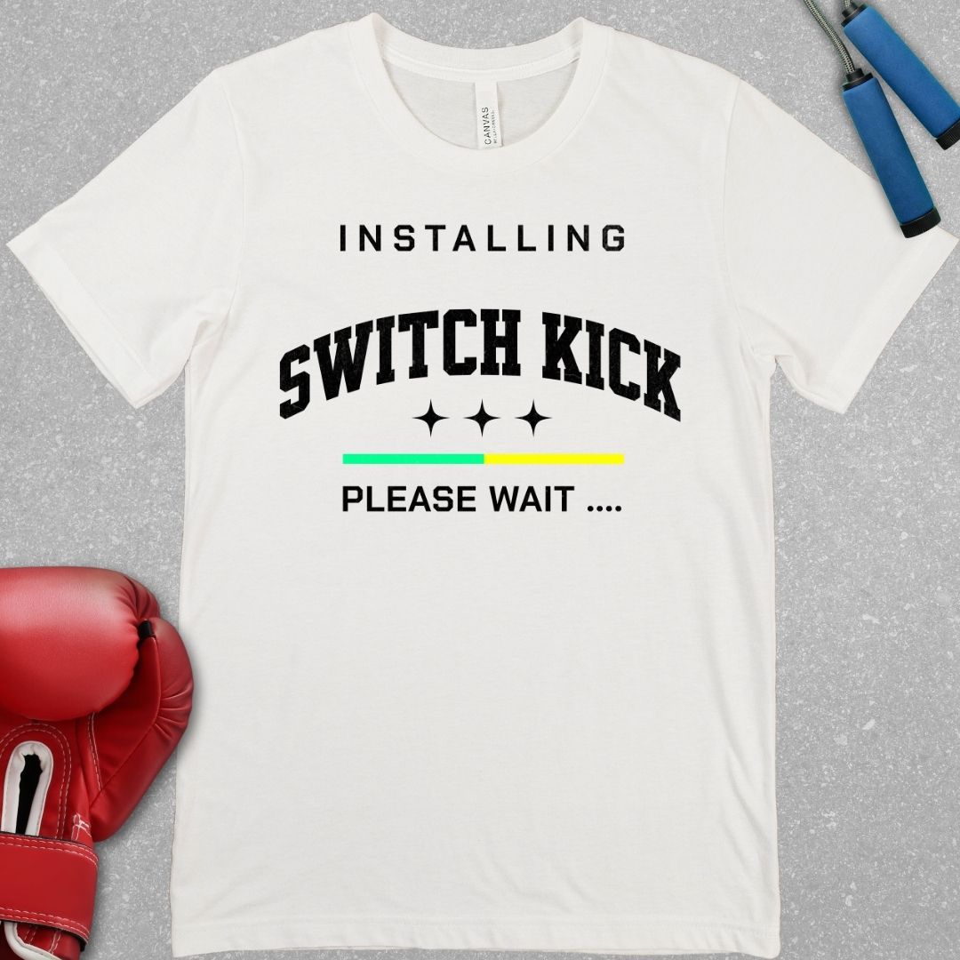 White shirt with black writing that says INSTALLING SWITCH KICK PLEASE WAIT.