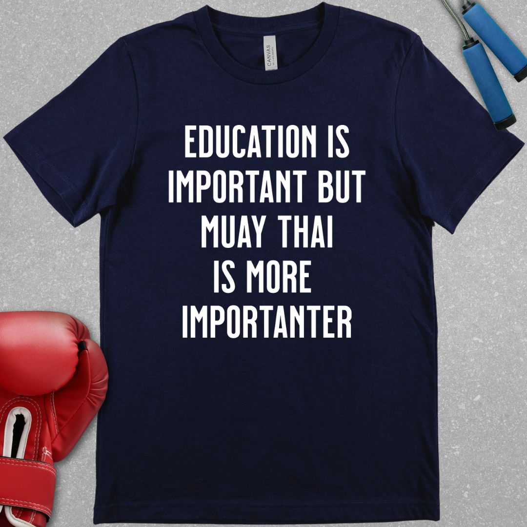 Navy shirt with text that says Education is important but Muay Thai is more importanter