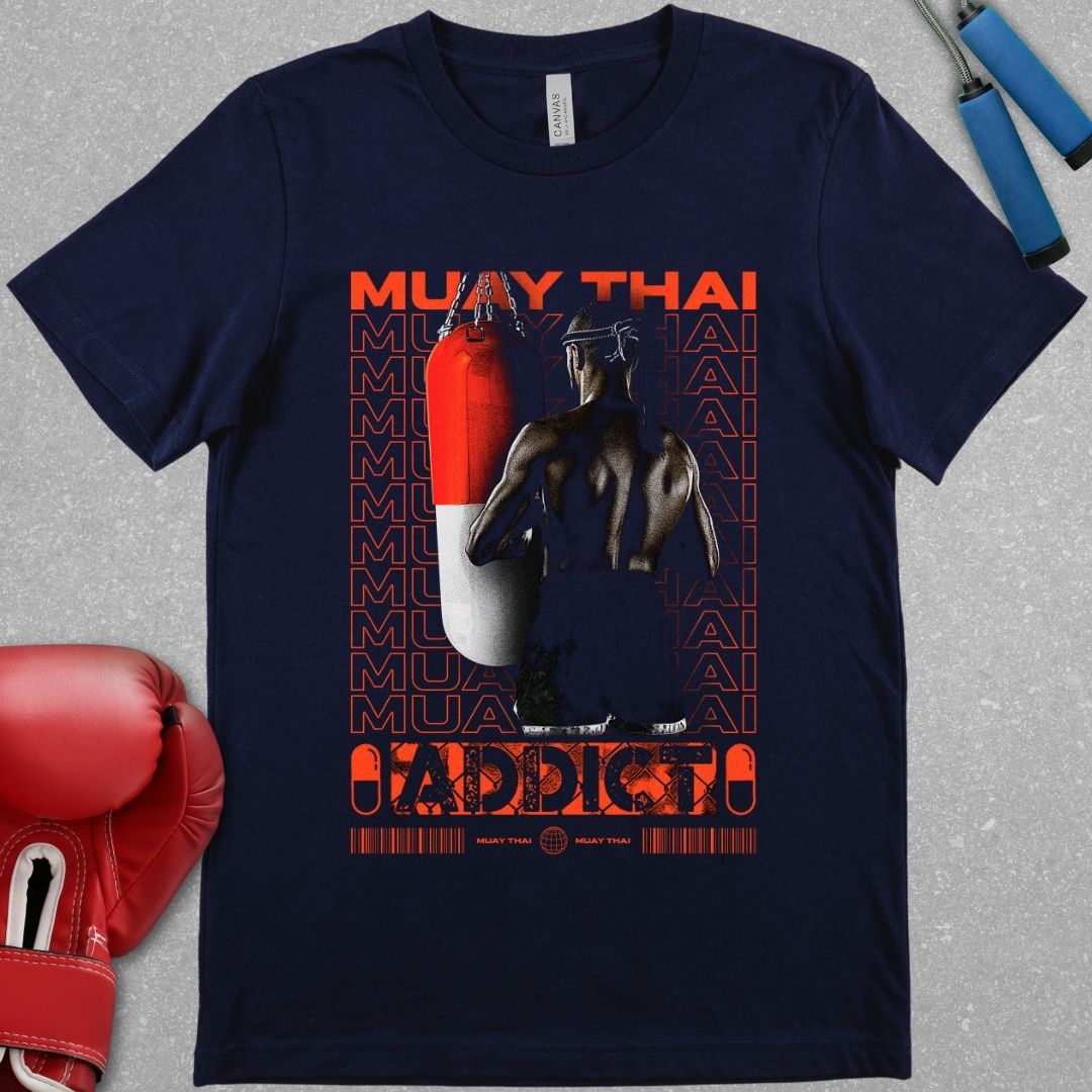 Navy shirt with a design that says Muay Thai addict and it has a picture of a Muay Thai fighter facing a Muay Thai bag.