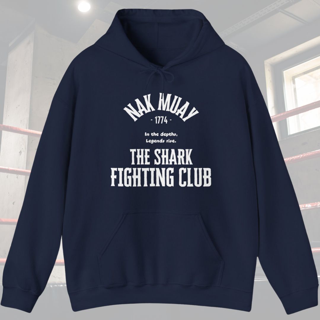 Navy hoodie with typography design. Has the words Nak Muay at top of design with the following phrase in the middle In the depths, Legends rise. Also has the words The Shark Fighting Club at the bottom of the design.