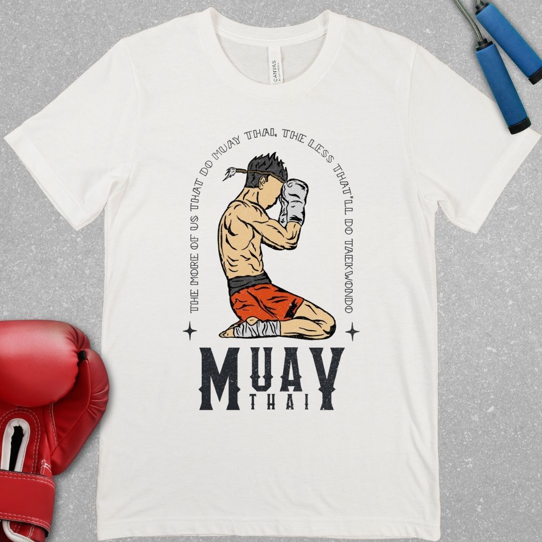 White shirt that has a design of a Muay Thai fighter in the Wai Khru with the phrase – “The more of us that do Muay Thai, the less that'll do Taekwondo”. The words Muay Thai are also written at the bottom of the design.