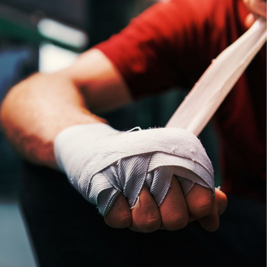 picture of a person wrapping up their hands for self defense training. The picture relates to a blog as to why Muay Thai is good for self defense